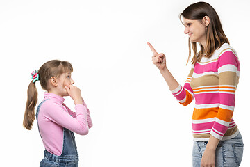 Image showing Mom shows the index finger to the girl, daughter looks at mom in fear