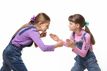 Image showing two girls quarrel and fight with each other on a white background