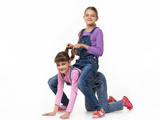 Image showing Girl sits on top of another girl like a horse