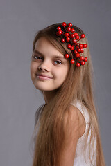 Image showing Portrait of a ten year old girl with a bunch of berries in her hair