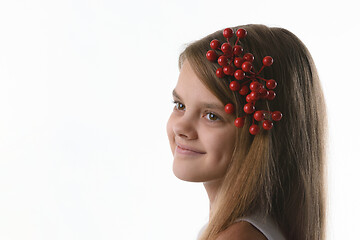 Image showing Closeup portrait of a ten year old girl with a bunch of berries in her hair