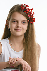 Image showing Portrait of a girl of Slavic appearance with a bunch of berries in her hair close-up