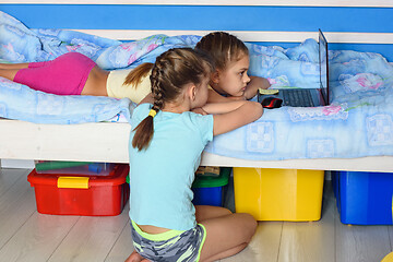 Image showing Children watch cartoons on a laptop screen.