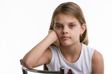 Image showing Portrait of a pensive ten year old girl on a white background