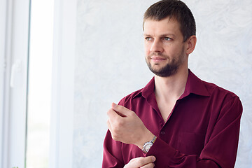 Image showing young man in the morning dresses shirt while going to office work