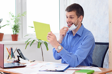 Image showing Cheerful office employee communicates with partners by video link and shows the language