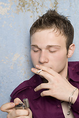 Image showing portrait of the young man with a cigarette and a lighter