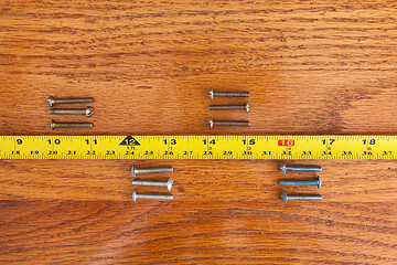 Image showing Screws and a tape measure