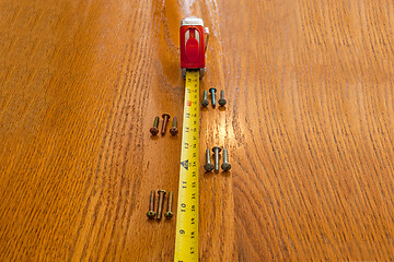 Image showing Screws and a tape measure