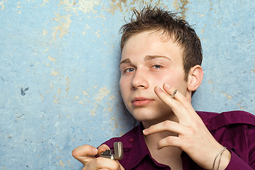 Image showing portrait of the young man with a cigarette and a lighter 2