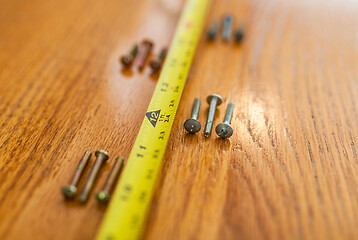 Image showing Screws and a tape measure