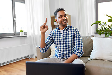 Image showing indian male blogger pointing finger up at home