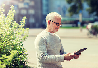 Image showing senior man with tablet pc on city street