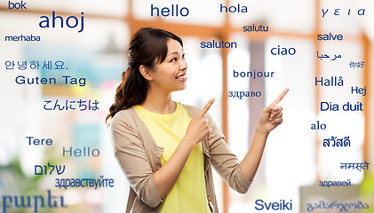 Image showing asian woman pointing fingers to foreign words