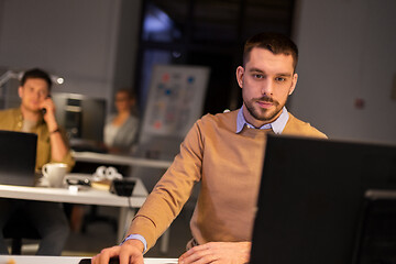 Image showing man with computer working late at night office