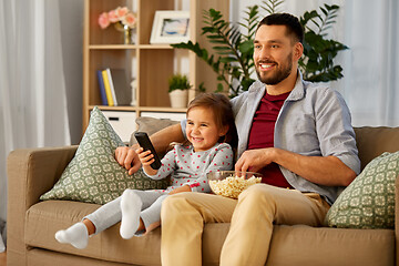 Image showing happy father and daughter watching tv at home