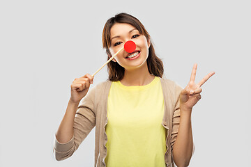 Image showing asian woman with red clown nose showing peace