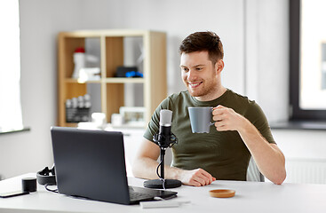 Image showing blogger with laptop and microphone audio blogging