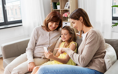 Image showing mother, daughter and grandmother with smartphone