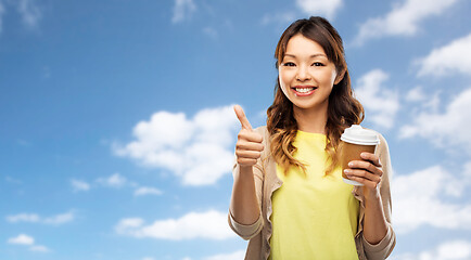 Image showing asian woman drinking coffee and showing thumbs up