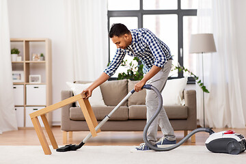 Image showing indian man with vacuum cleaner at home