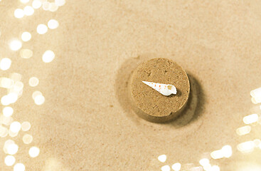 Image showing sand shape made by mold with shell on summer beach