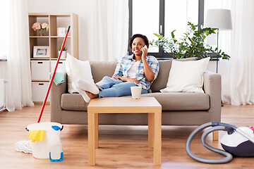 Image showing woman calling on smartphone after home cleaning