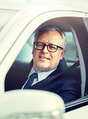 Image showing happy senior businessman driving car