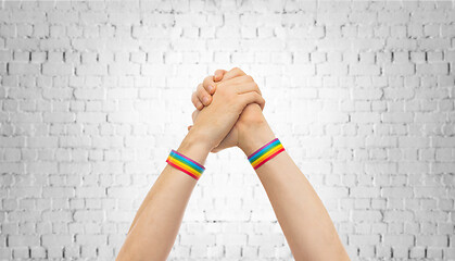 Image showing hands with gay pride wristbands in winning gesture