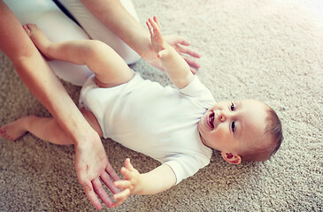 Image showing happy mother playing with baby at home