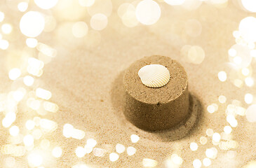 Image showing sand shape made by mold with shell on summer beach