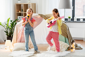 Image showing girls with guitar and microphone playing at home