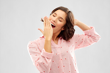 Image showing happy young sleepy woman in pajama yawning