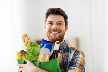 Image showing smiling young man with food in bag