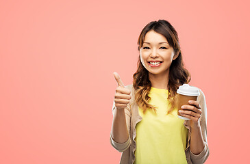 Image showing asian woman drinking coffee and showing thumbs up