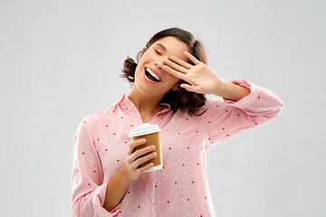 Image showing happy young woman in pajama with cup of coffee