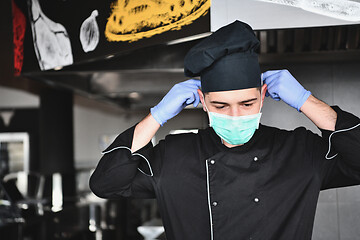 Image showing chef cook wearing face protective medical mask for protection fr