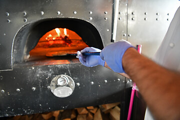 Image showing chef  with protective coronavirus face mask preparing pizza