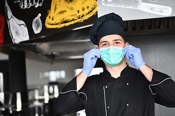 Image showing chef cook wearing face protective medical mask for protection fr