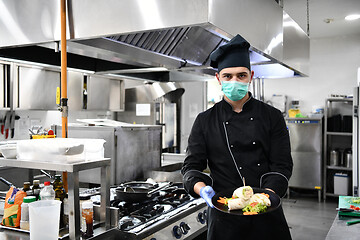 Image showing chef cook wearing face protective medical mask for protection fr