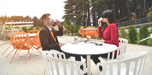 Image showing couple with protective medical mask  having coffee break in a re