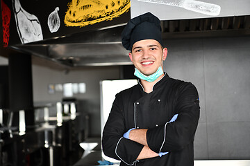 Image showing chef cook wearing face protective medical mask for protection fr