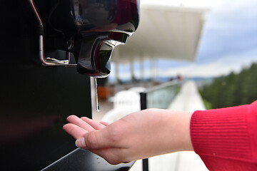 Image showing hands disinfection in restaurant