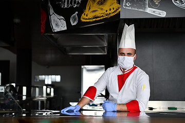 Image showing chef cook wearing face protective medical mask for protection fr