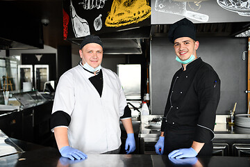 Image showing group chefs standing together in the kitchen at restaurant weari