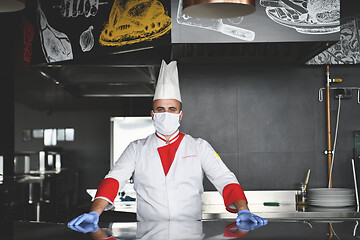 Image showing chef cook wearing face protective medical mask for protection fr