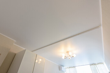 Image showing Classic white matte stretch ceiling with separation for curtains in two halves