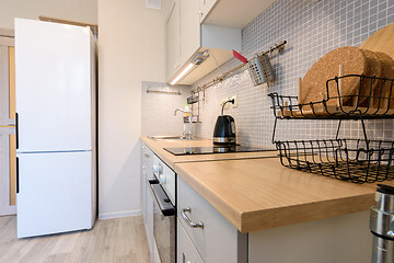 Image showing View along the countertop on a fragment of the interior of a modern kitchen