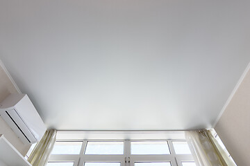 Image showing Fragment of the suspended ceiling above the window in the room, next to air conditioning