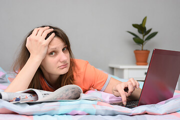 Image showing A girl cannot find work either on the Internet or in newspaper ads